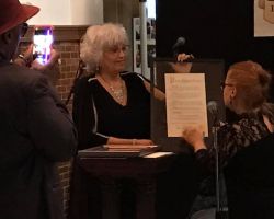 Maria Cruz, the executive director of the iconic Taino Towers complex in the Spanish Harlem district of Manhattan, New York City, receives an award from Leticia Rodriguez, the executive director of La Casa de la Herencia Cultural Puertorriqueña.